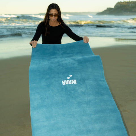 turquoise travel yoga mat being modeled by young female