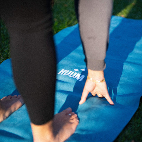 turquoise travel yoga mat being used for poses